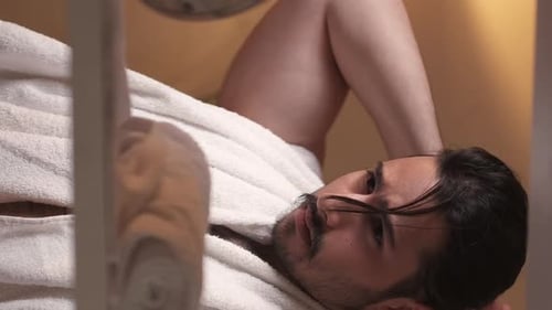 Man Relaxing with White Robe