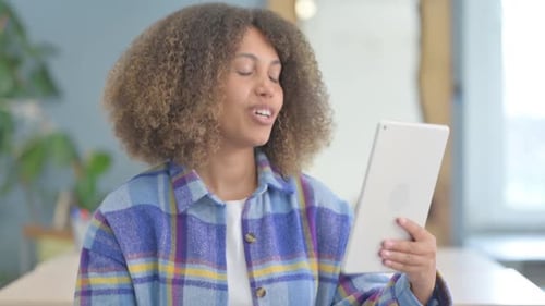 Portrait of Young African Woman Doing Video Chat on Tablet