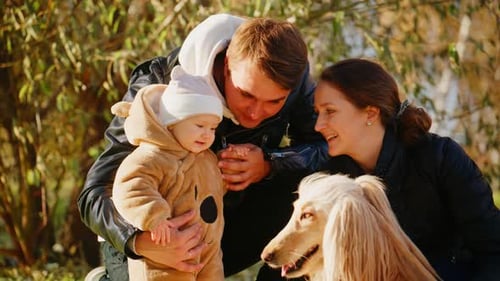Loving Family with Baby and Dog in Park