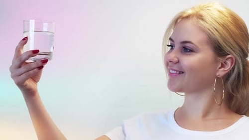 Woman Holding Glass of Water Smiling