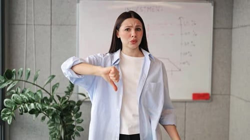 Woman Giving Thumbs Down to Investment in Workplace