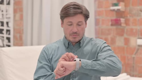 Man Using a Smart Watch Indoors, Close Up