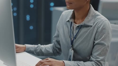 Young Adult Working at Computer in Modern Office