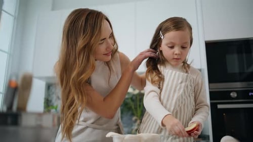 Woman and Girl Slicing Fruit in Kitchen