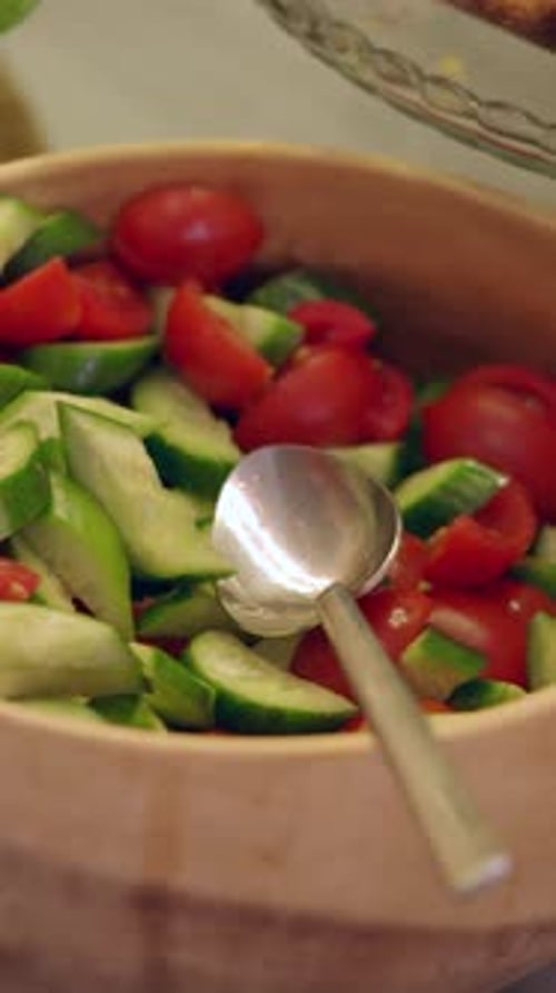 Wooden bowl with tomatoes and cucumbers salad