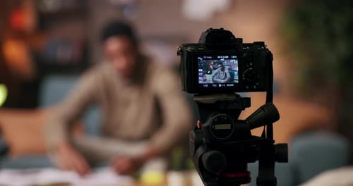 Health Fitness Coach in Living Room Inspires Viewers to Prioritize Health Wellbeing Holding Notepad