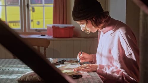 Young Artist Painting at Home with Watercolor Paints