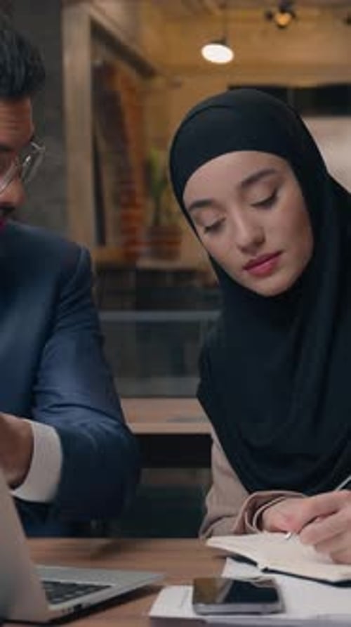 Concentrate Business Team in Office with Laptop Partnership Discuss Writing Notes Muslim