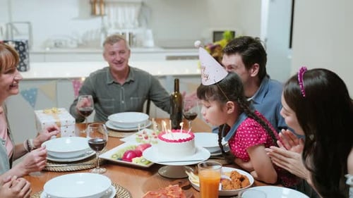 Family Celebrates a Birthday With Cake and Joy