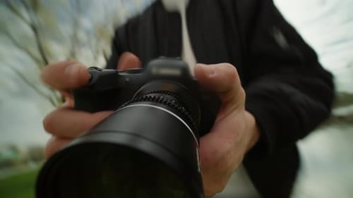 Adult Photographer Taking Close Up Photo with Camera