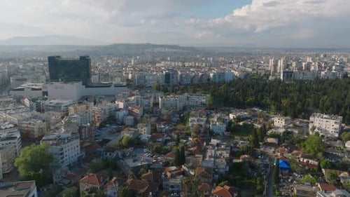 Aerial Panoramic View of Buildings in Metropolis Lit By Last Sun Rays of Day Fly Around Modern High