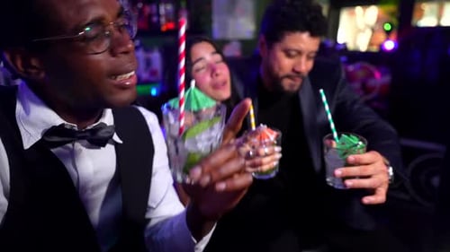 Friends Toasting at a Bar with Festive Cocktails