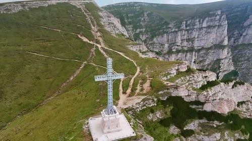 Huge metal cross monument set in the spectacular mountains. The Heroes' Cross on Mount Caraiman