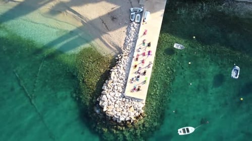 Active People Doing Daily Exercise On Pier By The Adriatic Sea In Brist, Dalmatia, Croatia. aerial t