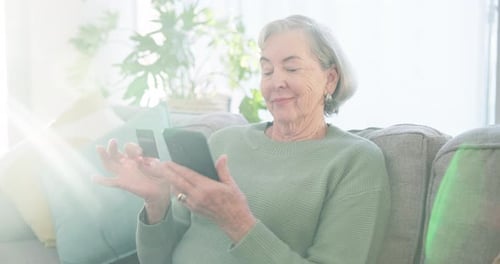 Senior Woman Uses Smartphone and Credit Card