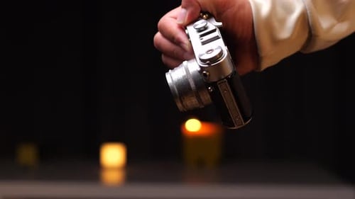 Hand Holding Retro Silver Camera Close Up