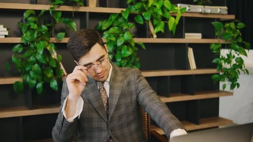 Young Adult Businessman Working at His Desk