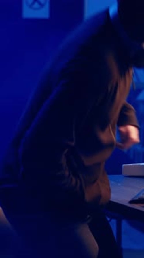 Vertical Video Hooded Hacker Creating Pirating Crack for Software and Video Game Releases