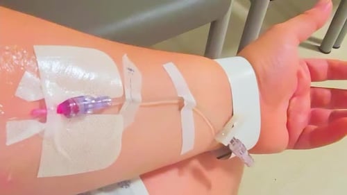 Male Caucasian olive skinned white person receives an intravenous pipeline access for medical profes