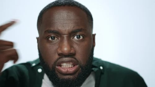 Portrait Angry Man Screaming in Studio. African American Guy Shouting on White