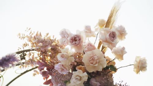 Close Up View of Wedding Floral Decorations Arch of Flowers in Pastel Faded Colors Outside Wedding