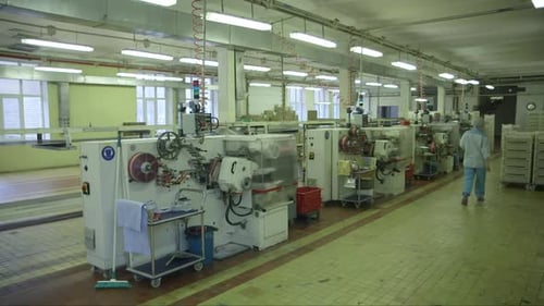 several lollipop packaging machines in a candy factory