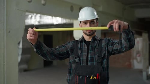 Man Inspector Builder Holding Measure Ruler Male Repairman Caucasian Guy on Construction Site