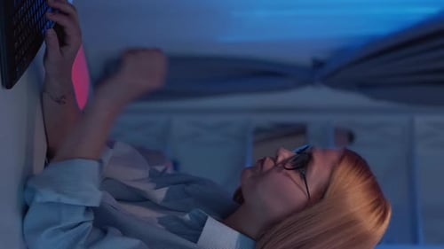 Woman Typing on Keyboard in Modern Lit Room