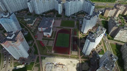 Aerial drone view of modern residential district and school sport ground in city