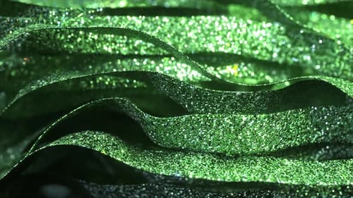 Luxurious Green Ribbons Glittering and Waving Smoothly Creating Elegant Festive Atmosphere with