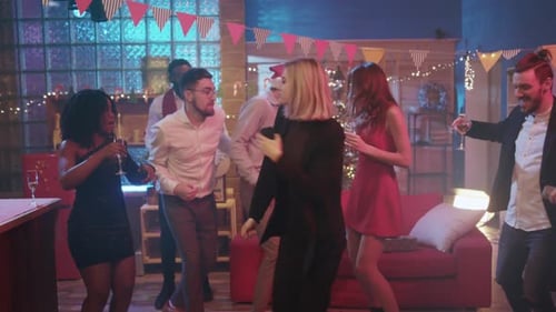 Festive Friends Dancing at a Holiday Party Indoors