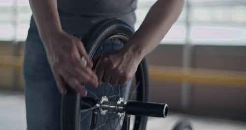 Close Up of Adult Working on Bicycle Tire