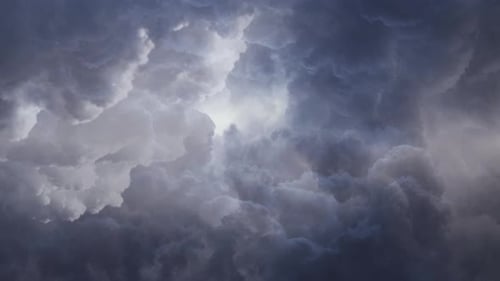 view of flying through dark clouds with bright light in the sky