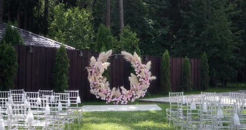 the Wedding Ceremony Area Where the Arch is Decorated with Pink Flowers