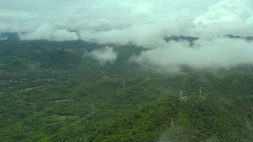 Aerial view clouds flowing over the mountain peak