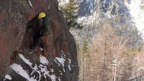 Climbing the Icy Heights A Fearless Man Conquers a Snowy Mountain Peak