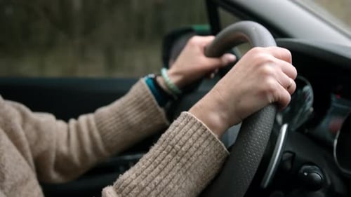 Close Up Woman Hands Driving Car
