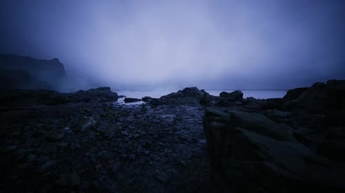 Dark and Foggy Seashore Panorama Displaying Intricate Shoreline Details
