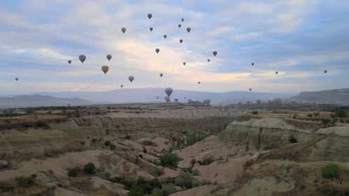 Hot Air Balloons Floating over Canyon at Sunrise