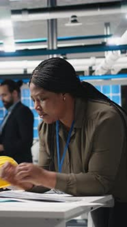 Vertical Video Black Engineering Expert Checking Data on Papers at the Solar Energy Factory