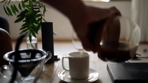 Pouring Coffee into Mug on Table