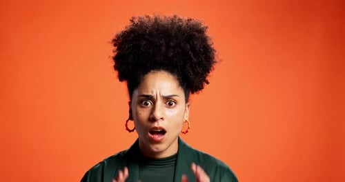 Face, shocked and woman in studio, secret and announcement on orange background