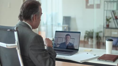 Man Attends Video Call in Bright Office