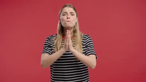 Young Woman Pleading with Hands Together