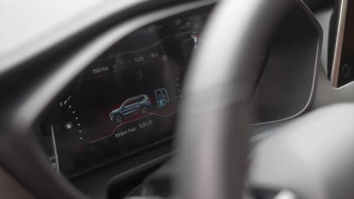 Car Dashboard Displaying Digital Gauges and Information