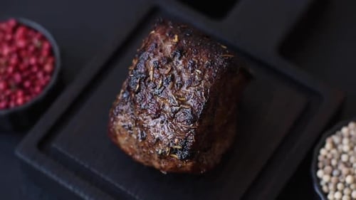 Delicious Seared Meat on Wooden Board with Spices