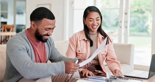 Smiling Couple Reviews Documents Together at Home