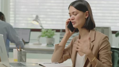 Businesswoman Having Phone Call in Office