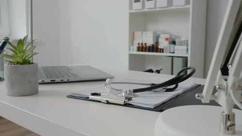 Stethoscope and Laptop on Desk in Doctor's Office