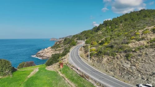 Aerial Video of Curved Road By Seaside Mountain